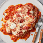 Chicken Parmigiana accompanied with an Authentic Sicilian Arancini