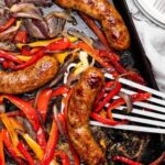 Homemade Roasted Fresh Sausages with Red Peppers & Onions on Polenta