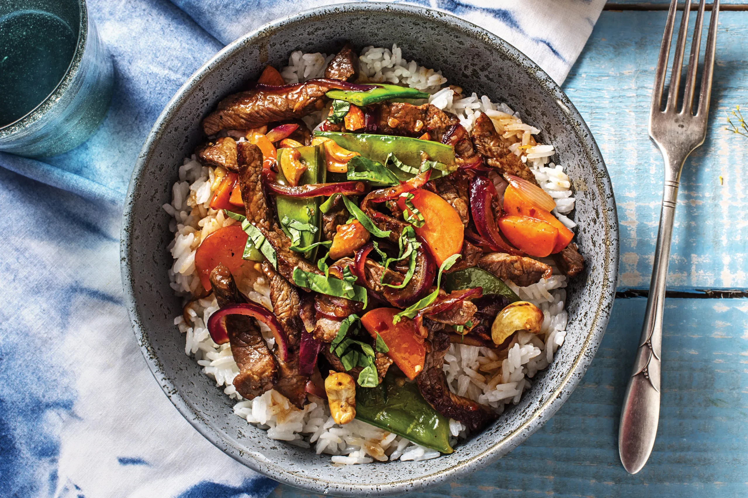 thai-beef-snow-pea-stir-fry-8ed5f078 Beef & Basil Stir Fry with Summer Vegetables over Steamed Rice - Image 1